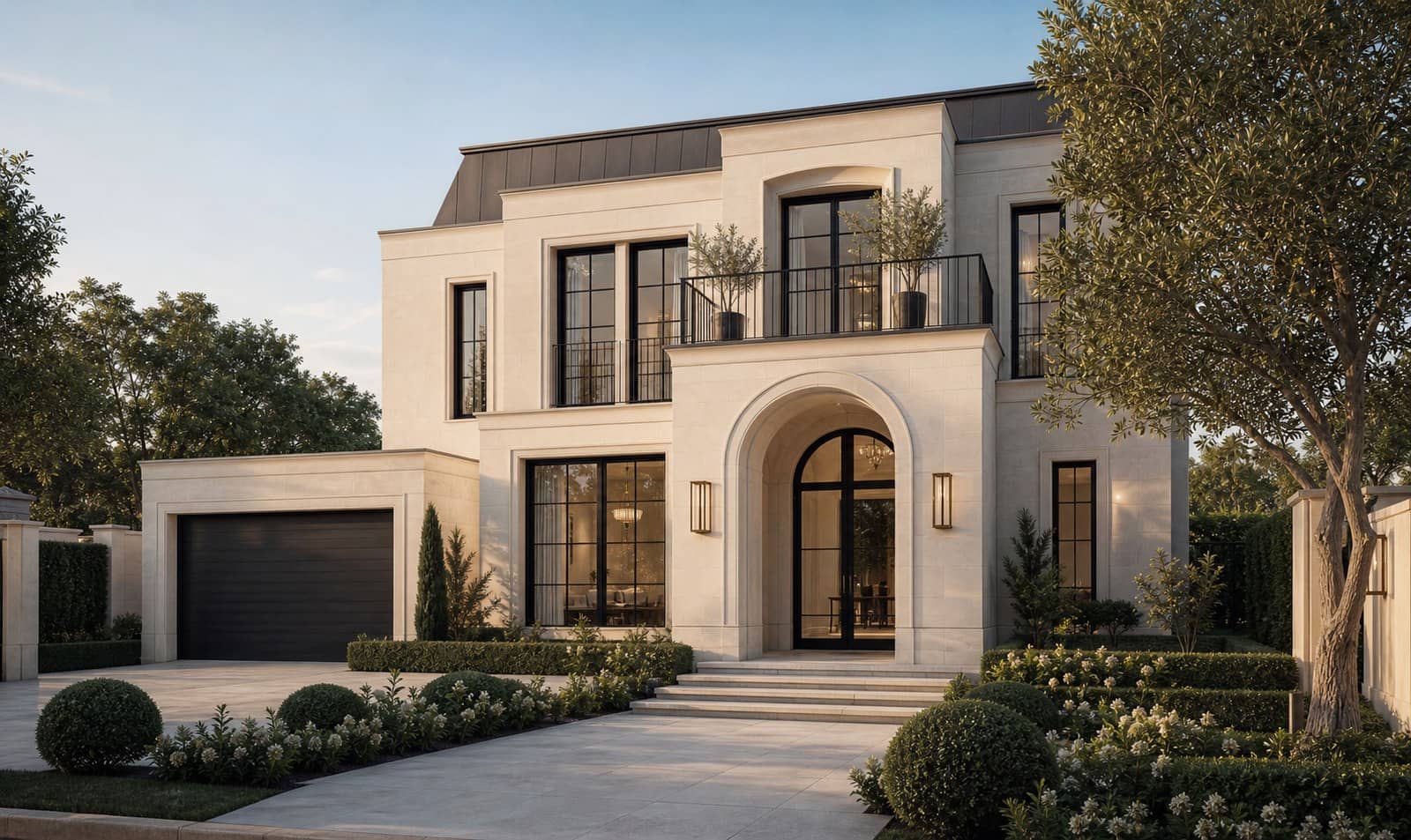 French contemporary luxury home exterior with pale limestone, arched entry and landscaped garden
